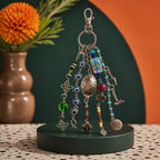 Ariel La Boutique bohemian beaded bag charm featuring evil eye beads, silver charms, and a Luck coin on a lobster clasp.