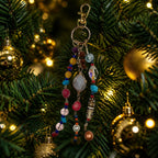 Ariel La Boutique multi-colored beaded keychain with crystals and stones hanging on a festive Christmas tree.