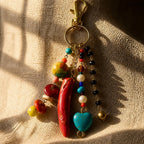 Ariel La Boutique bohemian beaded keychain featuring a red horn charm, turquoise heart, pearls, and crystals on gold.