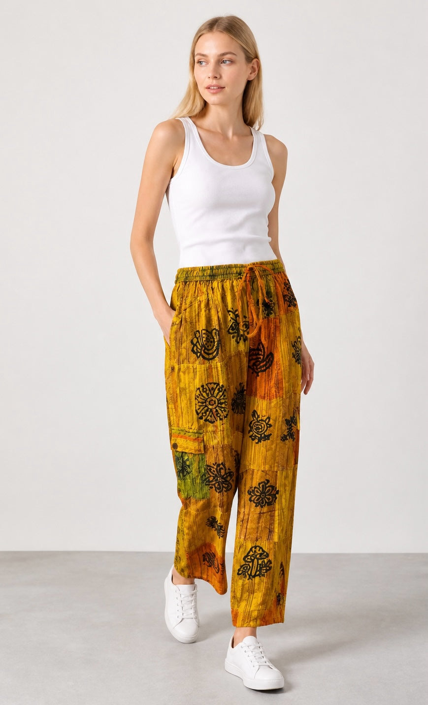 Ariel La Boutique wide-leg cargo pants in yellow and orange with black floral block prints and an elastic waistband.
