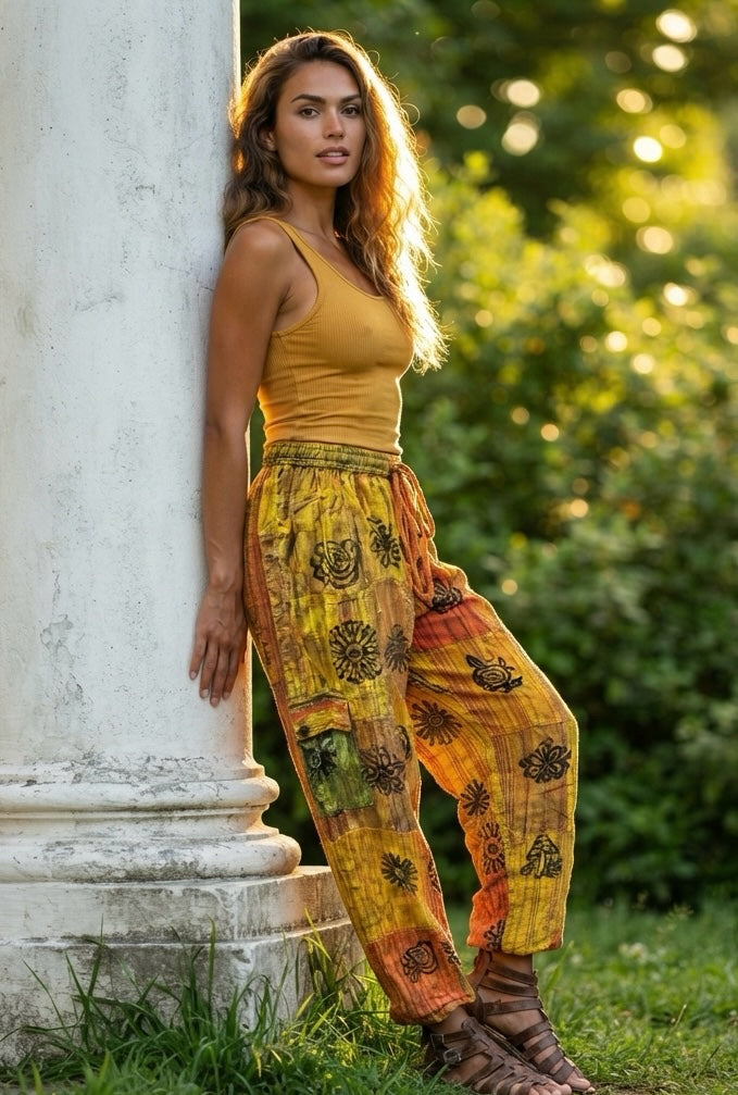 Ariel La Boutique bohemian wide-leg cargo pants in yellow and orange patchwork with floral prints on a model.