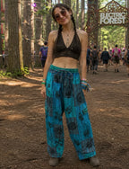 Ariel La Boutique bohemian wide-leg lounge pants in teal and blue patchwork with black floral block-print motifs.