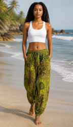 Ariel La Boutique green patchwork harem pants with a drawstring waist worn by a woman on a sunny beach.