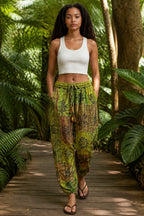 Ariel La Boutique green patchwork harem trousers with an elastic drawstring waist and ankle cuffs worn by a model in a forest