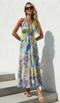 Ariel La Boutique bohemian halter neck maxi dress in lime green and blue paisley print with a tiered flowy skirt.