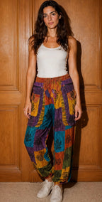 Ariel La Boutique bohemian patchwork cargo joggers with multi-colored panels, zipper pockets, and a relaxed fit.