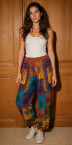 Ariel La Boutique bohemian patchwork cargo joggers with multi-colored patterns, elastic waist, and zipper pockets.