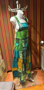 Ariel La Boutique bohemian patchwork overall dress in green, teal, and mustard cotton with shirred shoulder straps.