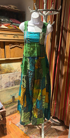 Ariel La Boutique bohemian patchwork overall dress in green, teal, and mustard cotton with wide shirred straps.