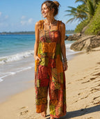 Ariel La Boutique bohemian patchwork wide-leg jumpsuit in earthy tones with ruffled straps worn by a woman on a beach.